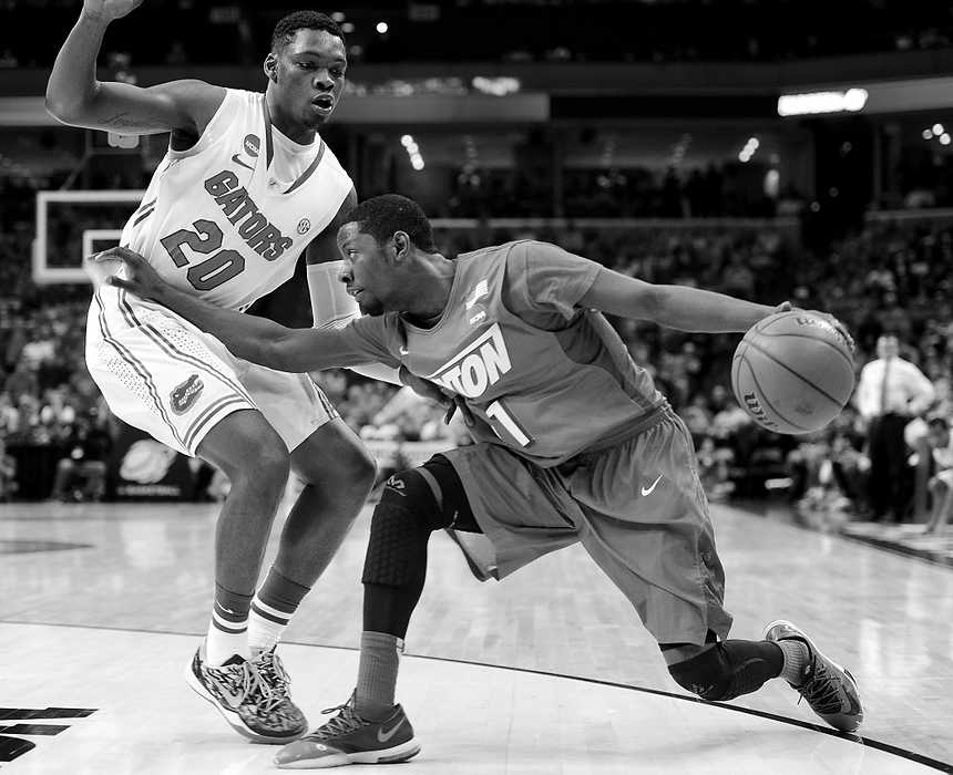 Second Place, Ron Kuntz Sports Photographer of the Year - Erik Schelkun / Elsestar ImagesScoochie Smith attacks the Florida defense during the NCAA elite 8 matchup in Memphis.