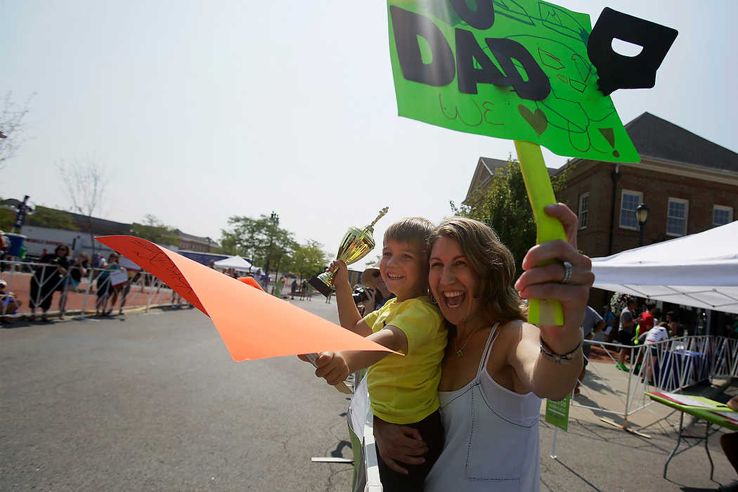Third Place, Ron Kuntz Sports Photographer of the Year - Logan Riely / Ohio UniversityMichelle Kohn and her son Gabriel, 4, of Cincinnati, Ohio, cheer on their father and husband Chase as he crosses the 180 mile finish line at Market Square in New Albany to end the 6th annual Pelotonia.