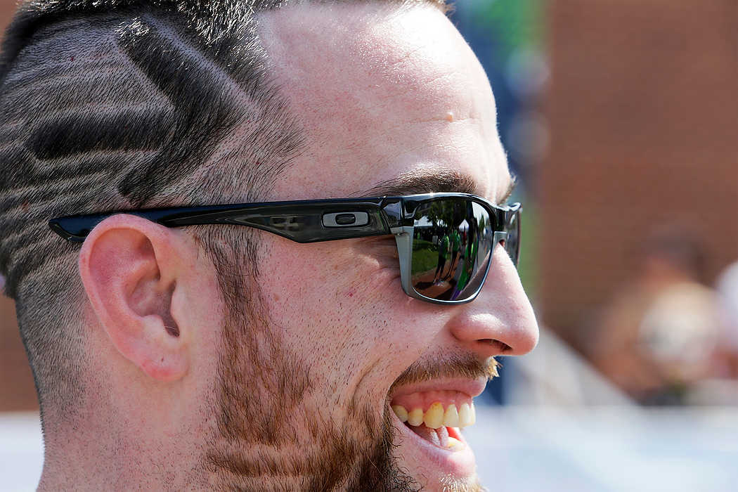 Third Place, Ron Kuntz Sports Photographer of the Year - Logan Riely / Ohio University100 mile rider Dean McCombs of Lima said, "my barber took three hours to cut this and he did it for free to support my ride." while at Market Square for the 180 mile finish line in New Albany to end the 6th annual Pelotonia.