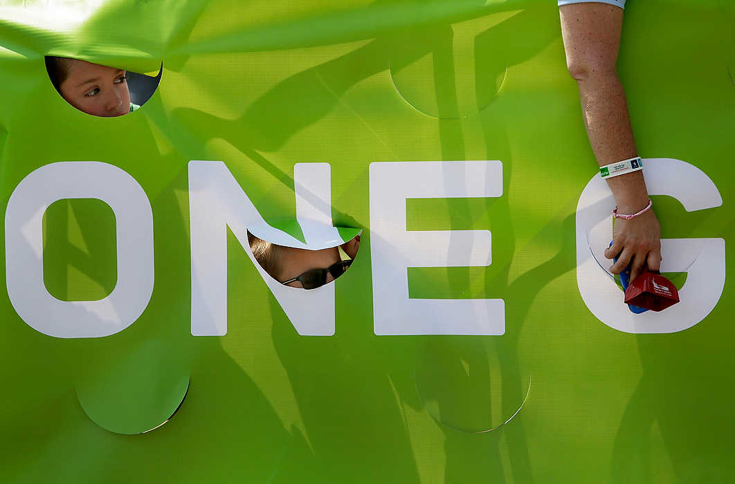 Third Place, Ron Kuntz Sports Photographer of the Year - Logan Riely / Ohio UniversityTwins Connor and Braden Hesson, 7, of Hilliard, Ohio, watch riders crossing the 180 mile finish line at Market Square in New Albany to end the 6th annual Pelotonia.