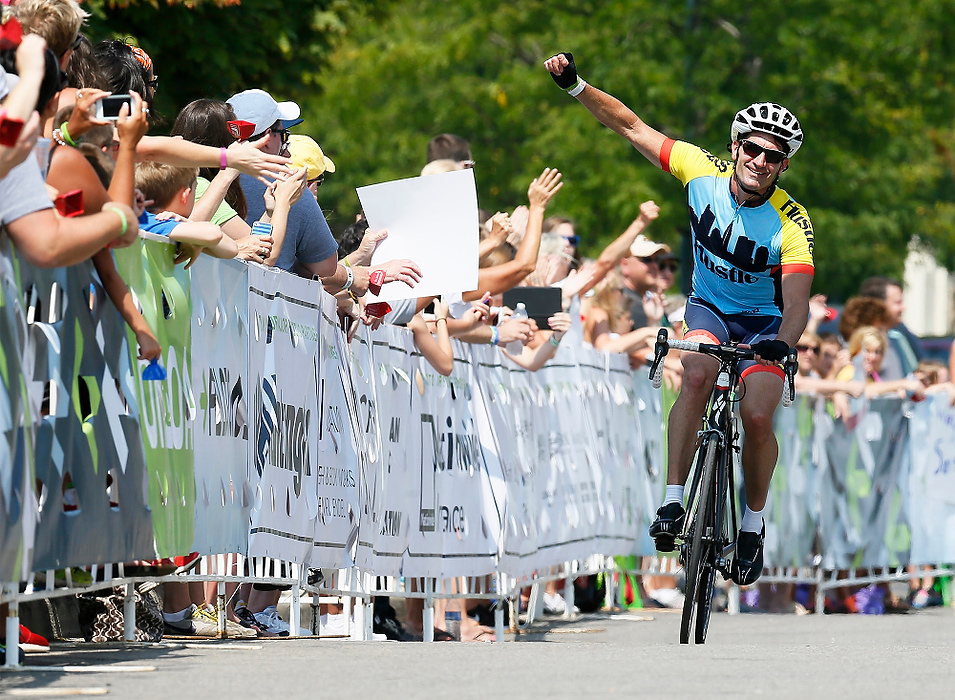 First Place, Student Photographer of the Year - Logan Riely / Ohio UniversityRiders celebrate crossing the 180 mile finish line at Market Square in New Albany to end the 6th annual Pelotonia.