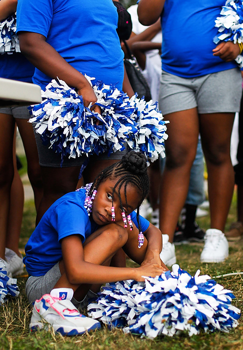 Second Place, Student Photographer of the year - Isaac Hale / Ohio UniversityEnyjah Reeb, 6, looks over at the crowd during the annual 2 Mile March and Rally 2 Stop Gun Violence in Toledo as she crouches among other Thunderbolt cheerleaders. The march went from the intersection of Central and Detroit Avenues to the Intersection of Detroit and Indiana Avenues.