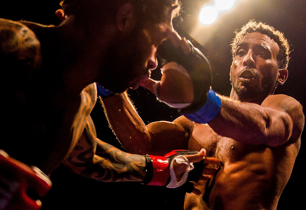 Second Place, Student Photographer of the year - Isaac Hale / Ohio UniversityRandal Burton (right) pushes away Keith Speed (left) to avoid Speed's upcoming punch during an amateur Mixed Martial Arts fight at the LC Pavilion in Columbus as part of the 2014 Arnold Sports Festival. Burton won the 155 pound weight-class fight.