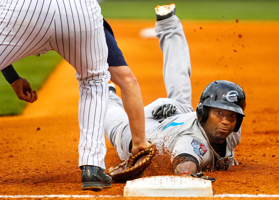 Second Place, Student Photographer of the year - Isaac Hale / Ohio UniversityToledo Mud Hens first basemen Jordan Lennerton tags out Syracuse Chiefs center fielder Brian Goodwin to close out the first inning at Fifth Third Field in Toledo.