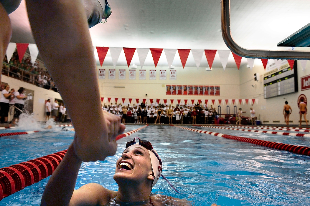 First Place, Student Photographer of the Year - Logan Riely / Ohio UniversityRed Devil swimmer Rachel Walker is congratulated by her 200 meter relay team after realizing they set a pool record by 0:00.53 of a second during the annual Jeffersonville vs Floyd Central swim meet held at the Jeffersonville aquatic center.