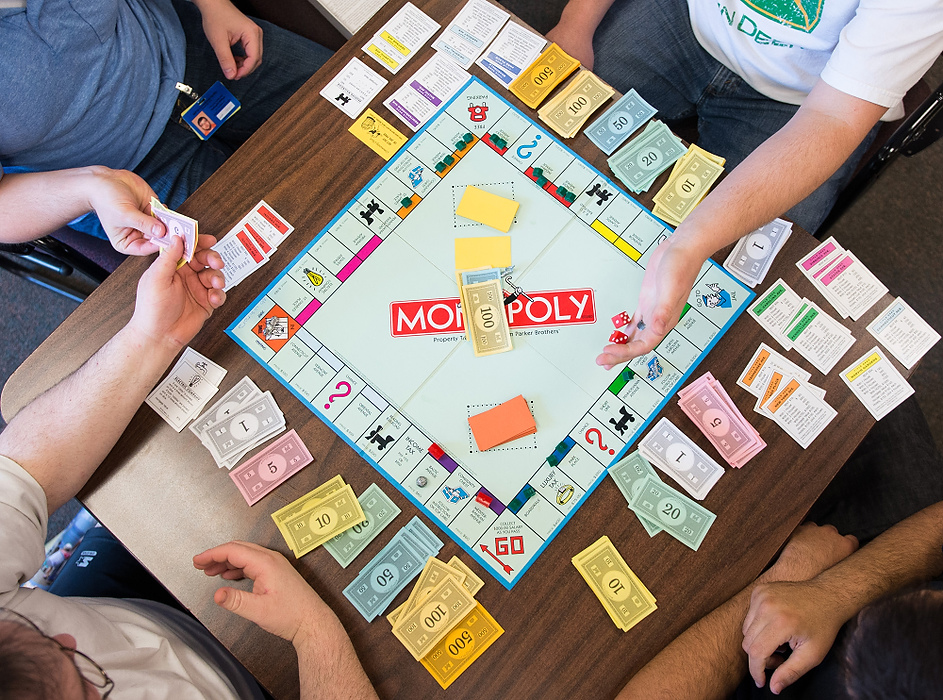 Second Place, Student Photographer of the year - Isaac Hale / Ohio UniversityDavid Jenkins, bottom left, hands William Holtzapfel, top left, play money as Jeff Swick, top right, rolls the dice and Frankie Sinco, bottom right, observes the game of Monopoly in the indoor recreational area of the west wing. Residents can play board games, watch television and exercise outside during their down time. 