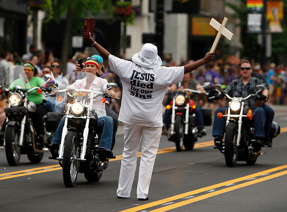 Third Place, Student Photographer of the year - Jenna Watson / Kent State University A single protestor is outnumbered by an oncoming group of parade motorcyclists during the annual Stonewall Columbus LGBT pride parade, in downtown Columbus.
