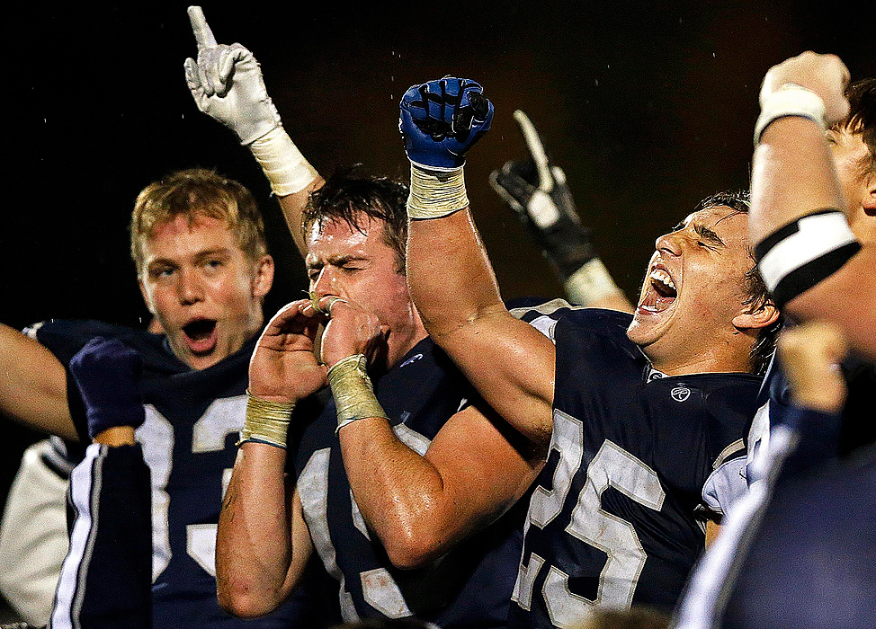 Third Place, Student Photographer of the year - Jenna Watson / Kent State University The Granville Blue Aces face the crowd reacting wildly in celebration after edging Licking Heights with a final score of 26-21, at Granville High School's stadium.