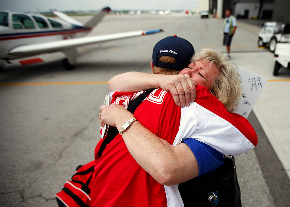 Third Place, Student Photographer of the year - Jenna Watson / Kent State University Cory Anatangelo, second baseman for the Ohio Special Olympics softball team, embraces his mother Pam Anatangelo as she fights emotions while welcoming him home from competition in New Jersey, at the Lane Aviation terminal of Columbus International Airport in Columbus. The softball team earned a gold medal in the competition. 