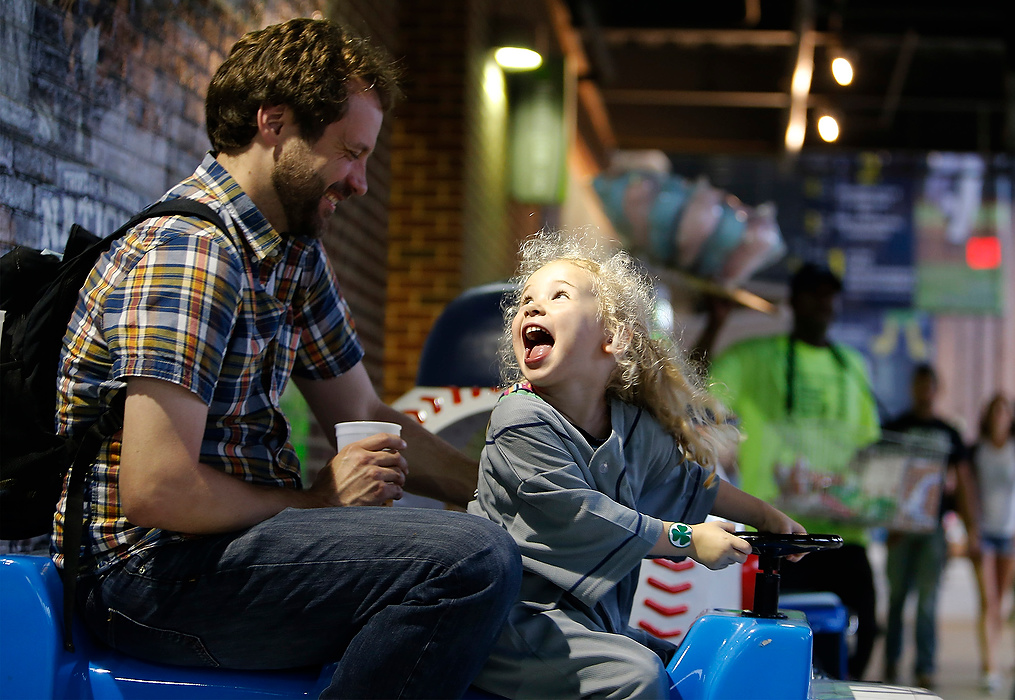 First Place, Student Photographer of the Year - Logan Riely / Ohio UniversityEd Forman of Clintonville, rides the toy train with his 3-year-old daughter Hattie during the Columbus Clippers vs Indianapolis Indians game at Huntington Park.