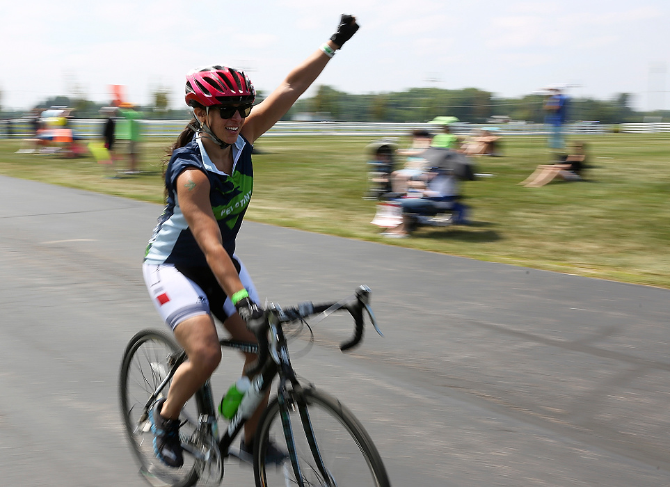 Third Place, Student Photographer of the year - Jenna Watson / Kent State University A bicyclist pumps her first as she passes through the 50-mile mark in New Albany during Pelotonia.
