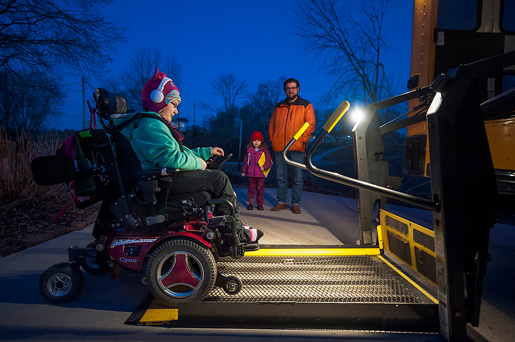 First Place, Student Photographer of the Year - Logan Riely / Ohio UniversityAdyn proceeds to get on the 7:15 a.m. bus to go to school while her dad Brian and younger sister Seneca watch on. According to Brian Bucher, Adyn’s father, there are only two busses that are handicap accessible in Athens County. “It makes my mornings more manageable especially when I have to take care of Seneca.”