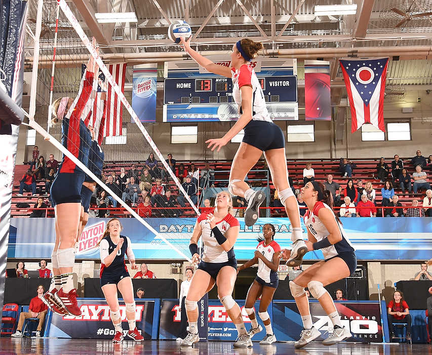 , Ron Kuntz Sports Photographer of the Year - Erik Schelkun / Elsestar ImagesDayton's Alaina Turner powers a shot over the net and past the Duquesne blockers during the first set at the Frericks Center on the campus of the University of Dayton. The Dayton Flyers downed Duquesne 3-1 to end the regular season with a 10 game winning streak.