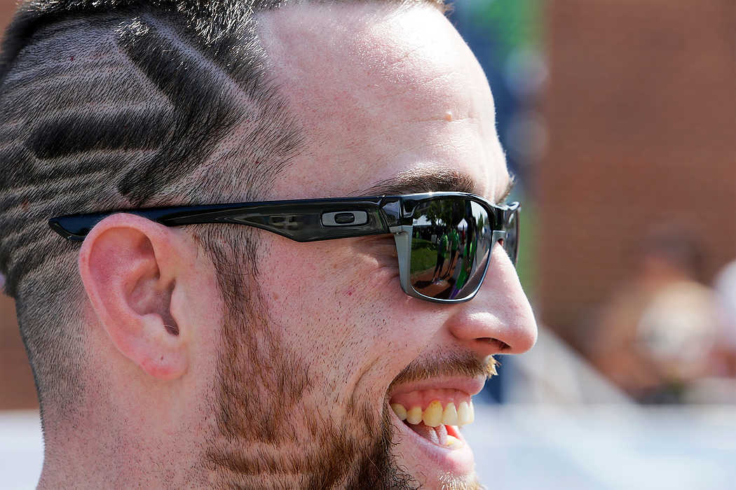Second Place, Sports Picture Story - Logan Riely / Ohio University100 mile rider Dean McCombs of Lima, Ohio, said, "my barber took three hours to cut this and he did it for free to support my ride." while at Market Square for the 180 mile finish line in New Albany o end the 6th annual Pelotonia.