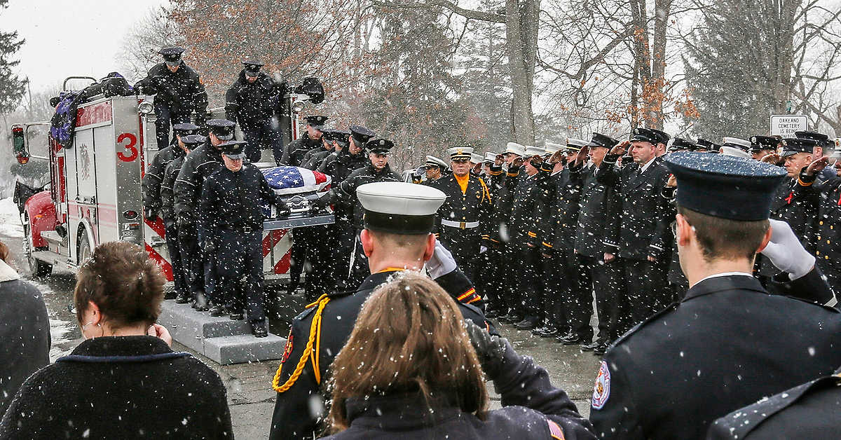 First Place, Team Picture Story  - Andy Morrison / The (Toledo) BladeFirefighters salute as the casket containing Toledo firefighter James Dickman arrives at Oakland Cemetery in Sandusky.