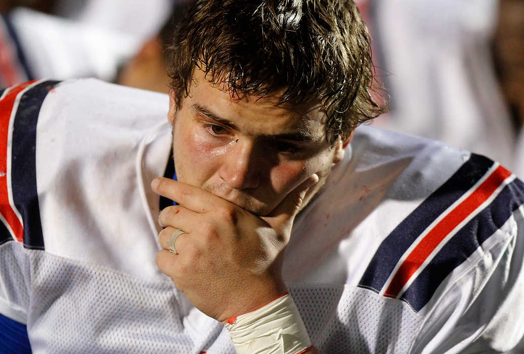 Second Place, Team Picture Story  - Lorrie Cecil / ThisWeek Community NewsBishop Hartley's Jared Croswell fights back tears as the team meets following their 34-24 loss to Canton Central Catholic in the Division 5 state semifinal game.