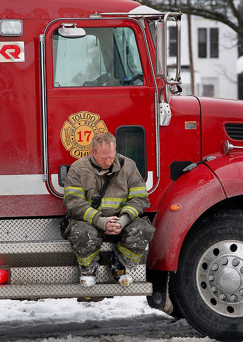 First Place, Team Picture Story  - Jetta Fraser / The (Toledo) BladeA Toledo fire fighter sits on a truck after two fellow firefighters were seriously injured while battling the blaze.  They were later pronounced dead at the hospital.