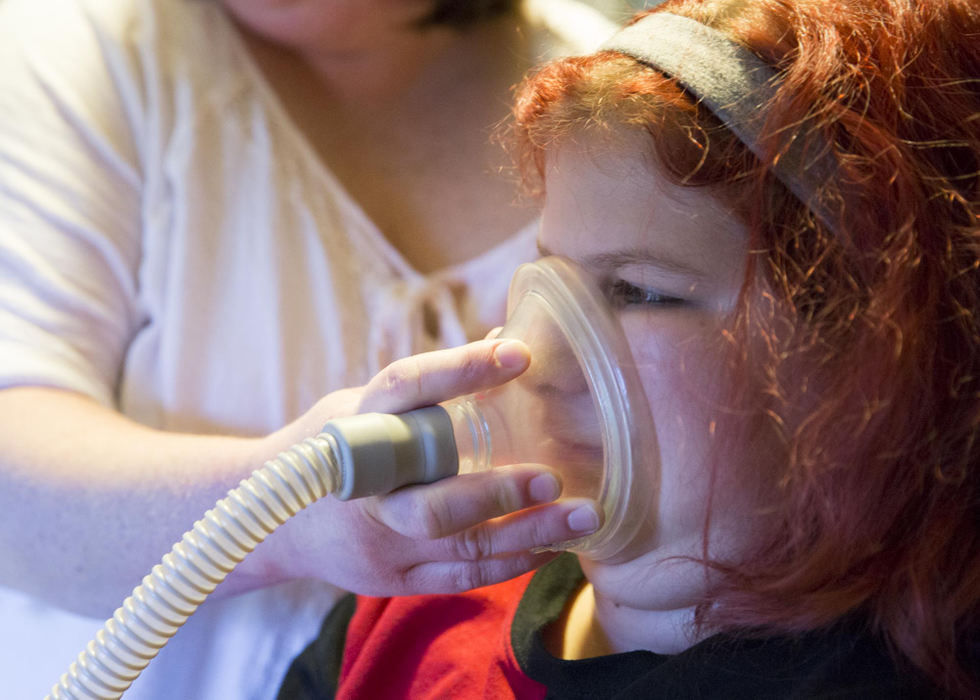 Second place, Larry Fullerton Photojournalism Scholarship - Alex Driehaus / Ohio UniversityAdyn coughs into a machine that registers the strength of her exhales. Subsequently a suctioned straw is used to remove the mucus that Adyn coughs up. 