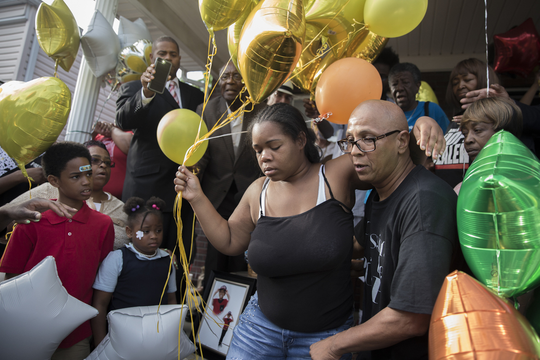 Best of Show - Liz Moughon / Ohio University2017 Best of Show - Liz Moughon/Ohio UniversityMicheshia Norment (left) holds onto friend Christopher 2X as she prepares to release balloons into the sky in memorial of her son, Dequante Hobbs Jr., 7, who was shot by a stray bullet through their kitchen window in the west end of Louisville, KY. Dequante was eating first grade graduation cake when he was accidentally shot by neighbors who were fighting.