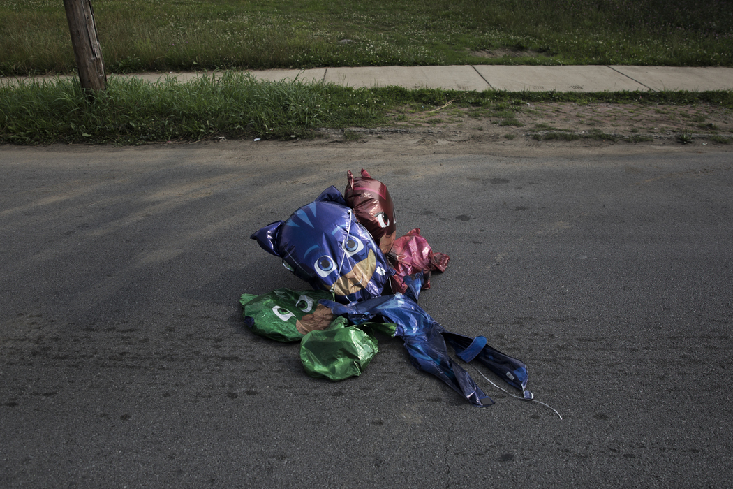 Best of Show - Liz Moughon / Ohio UniversityOver a month after Dequante's funeral, deflated Paw Patrol balloons blow into the street after barely holding onto his front porch rail. These were his favorite cartoon characters.