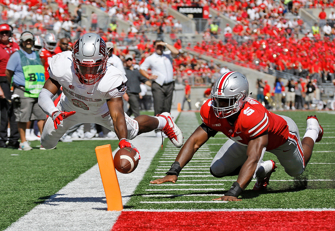 Second Place, Sports Action - Barbara J. Perenic / The Columbus DispatchUNLV Rebels running back Lexington Thomas (left) scores a touchdown while defended by Ohio State linebacker Baron Browning (5) during the second quarter of a game at Ohio Stadium in Columbus.