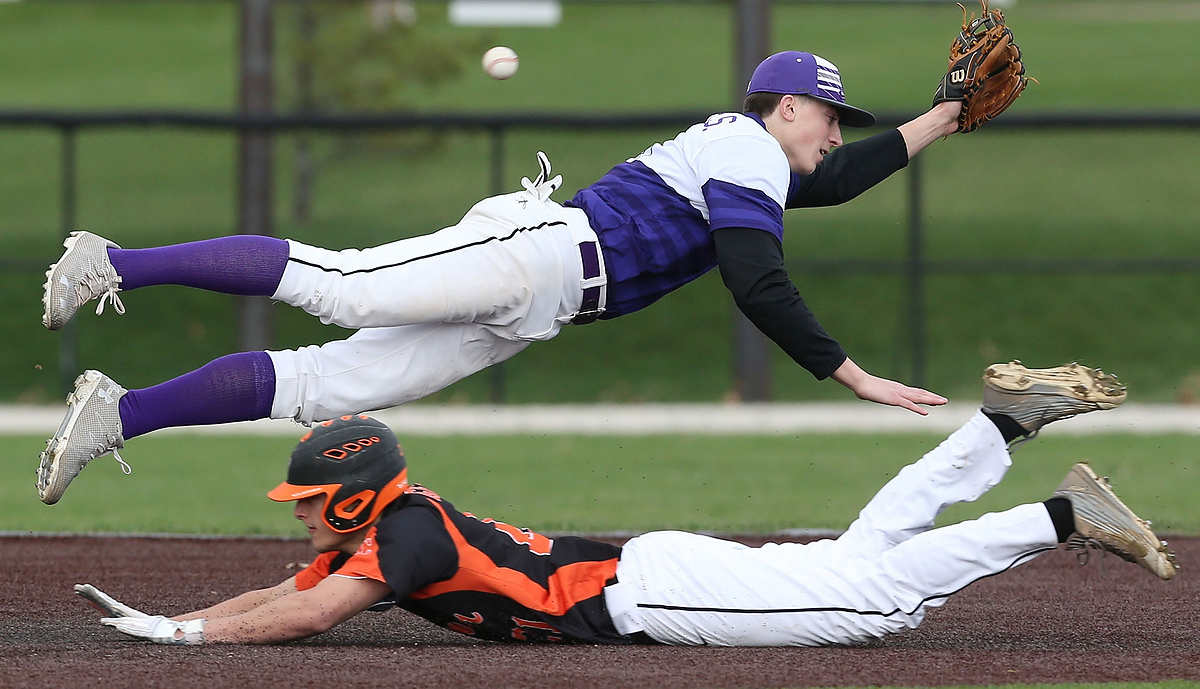 Third Place, Sports Action - Scott Heckel / The Canton RepositoryJackson's Kyle Nicolas leaps to field the ball as Hoover's Donnie Genetin steals second base in the third inning of their game in Jackson Township. 