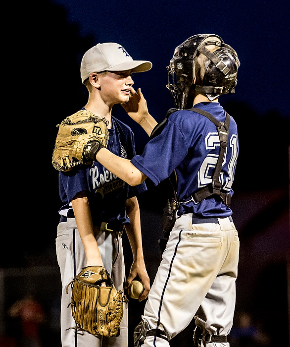 First Place, Sports Feature - Jessica Phelps / Newark AdvocateWill Robertson, the catcher for the Robertson Construction team, comforts the Jacob Eiam, the relief pitcher after he let a series of runs in, losing their lead over Licking Memorial Hospital in the final game of the Shrine Tournament. LMH won the game, 9-4, taking home the championship trophy. 