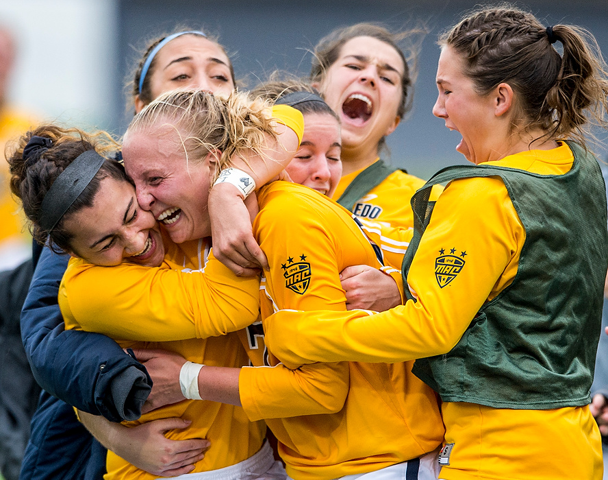 Second Place, Sports Feature - Nate Manley / Kent State UniversityMembers the University of Toledo Women’s Soccer team swarm senior forward Sophie Pohl after Pohl’s last second goal in overtime to give the Rockets a 2-1 win over Bowling Green in the MAC Championship at Dix Stadium in Kent.