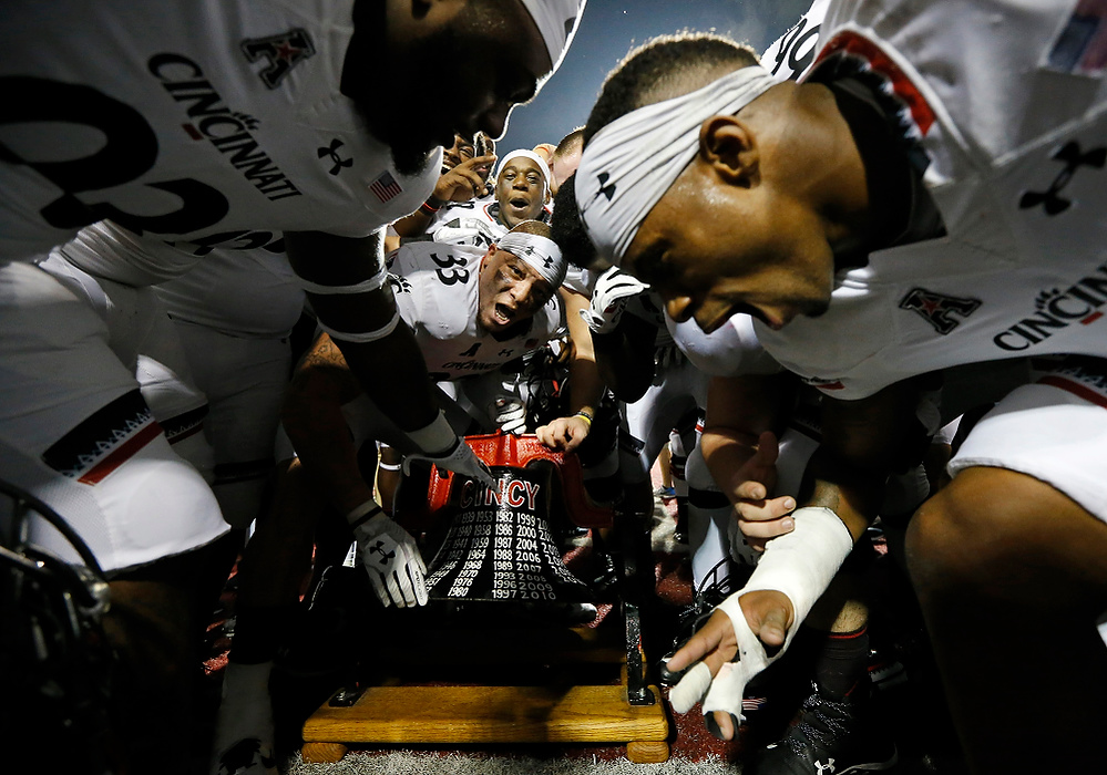 Award of Excellence, Sports Feature - Sam Greene / The Cincinnati EnquirerThe Cincinnati Bearcats celebrate with the Victory Bell after beating the Miami Redhawks at Yager Stadium in Oxford. UC retains the Victory Bell for the 12th-straight year.