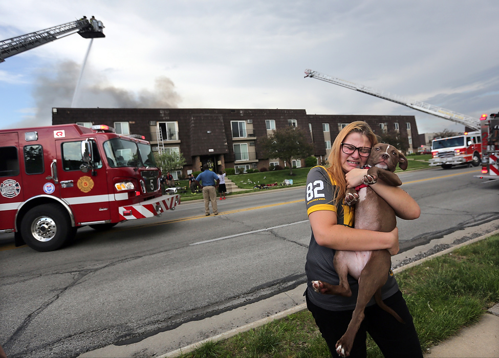 First Place, Spot News - Dave Zapotosky / The Blade Faith Kennedy tearfully hugs her dog, Luna, after Toledo firefighters rescued her from the fire at the Andover Apartments in the 2500 block of Eastgate Road in Toledo. 