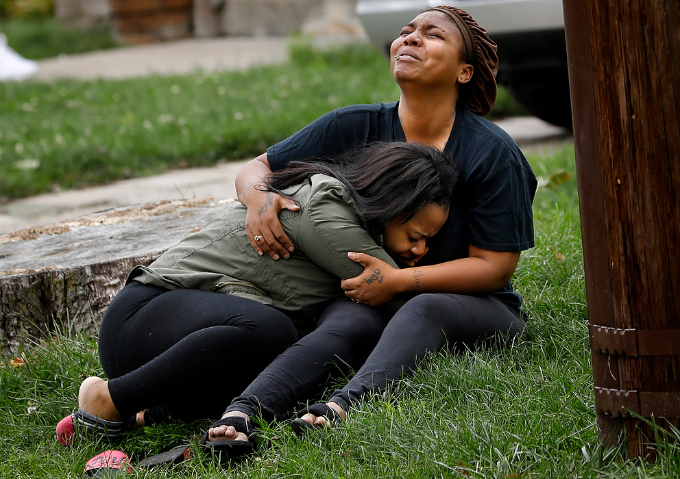 Award of Excellence, Spot News - Katie Rausch / The Blade"That's my baby," a woman sobs as another woman cries out, "That's my brother," while holding one another in the front yard as Toledo police investigate a shooting at 729 Brighton Ave. in South Toledo. Toledo police spokesman Sgt. Kevan Toney said an 18-year-old man and 18-year-old woman had been pronounced dead after the shooting. 