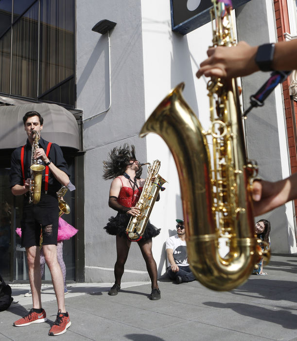 Second Place, Student Photographer of the Year - Liz Moughon / Ohio UniversityTimmy Wells, center, plays the baritone saxophone as part of the Burlesque Band of San Francisco on Castro Street after the Pride Parade on June 24, 2018.