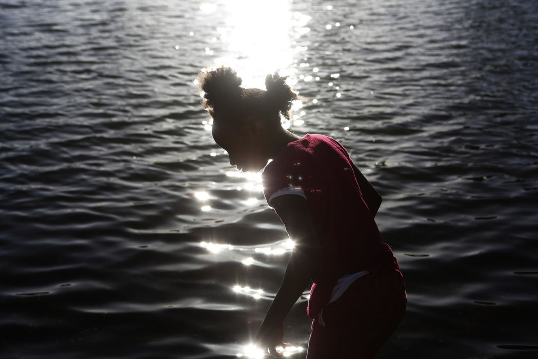 Second Place, Student Photographer of the Year - Liz Moughon / Ohio UniversityChloe Williams is silhouetted against Lake Merritt on an usually warm day in Oakland, Calif., on June 10, 2018.
