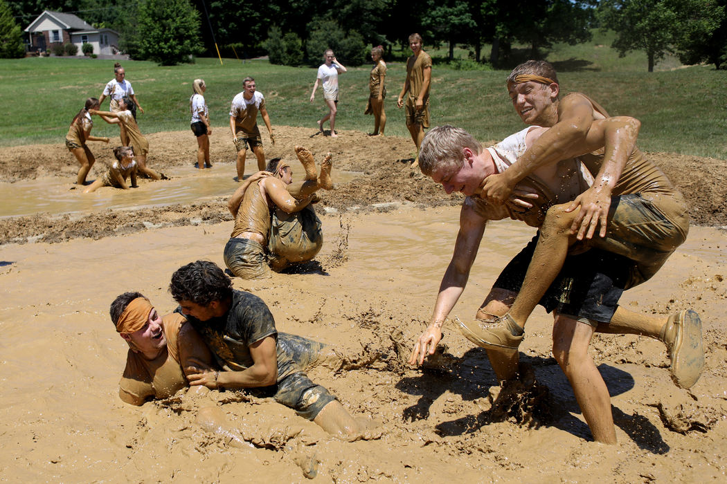 Third Place, Student Photographer of the Year - Marlena Sloss / Ohio UniversityJasper High School seniors Adam Jaent, right, tackles Garret Jacob while Nick Mendel, left, and Austin Simmers wrestle after their teams faced off in the senior class mud volleyball tournament at the school in Jasper, Ind. on May 23, 2018. Over ten teams participated in the annual tournament that takes place during the last week of school.