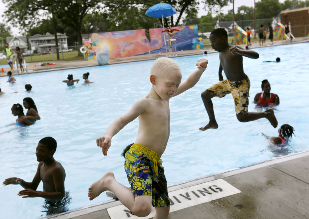 Second Place, Feature - Katie Rausch / The Blade, "Pool Fun"Karmero Sims (center) dances to music playing as other children jump into the newly-opened Roosevelt Pool during the seventh annual Smith Fest in Toledo on June 16, 2018. The festival featured horse rides from the Toledo Horsemen Club, a number of sports lessons, the opening of Roosevelt Pool, and a popular bike give-away. 