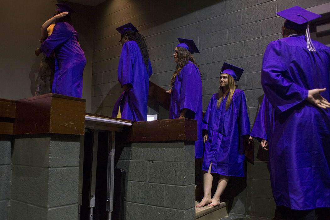 Second Place, Feature Picture Story - Marlena Sloss / Ohio University, " Teen Mother"After taking off her heels because of a blister, Brooke waits to walk on stage at graduation at AIS Diamond High School on May 22, 2018. "I was really nervous, but once I took my shoes off, I didn't have anything to be nervous about," Brooke said.