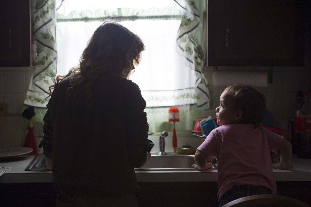 Second Place, Feature Picture Story - Marlena Sloss / Ohio University, "Teen Mother"Brooke does dishes in her home before going to work while keeping an eye on Vincent on Nov. 16, 2017. "I'm 17, but I feel like I've became an adult at an early age." While her father helps her care for Vincent, she is still expected to keep up with her household chores.