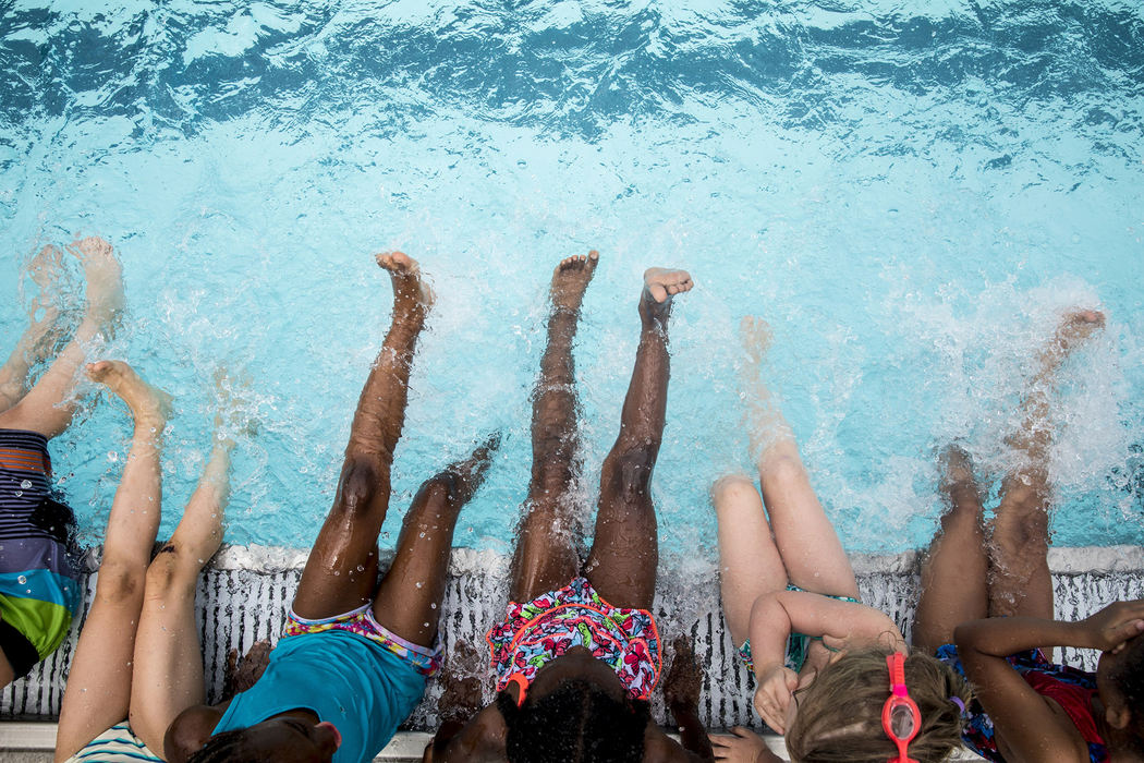 Third Place, Feature Picture Story - Meg Vogel / The Cincinnati Enquirer, "Rhinos"Dozens of young swimmers learn to kick in the water at Ziegler Pool during their first swim practice as the brand new swim team called Over-the-Rhine Rhinos, May 30, 2018. The swimmers range in ages from 4 to 13. 