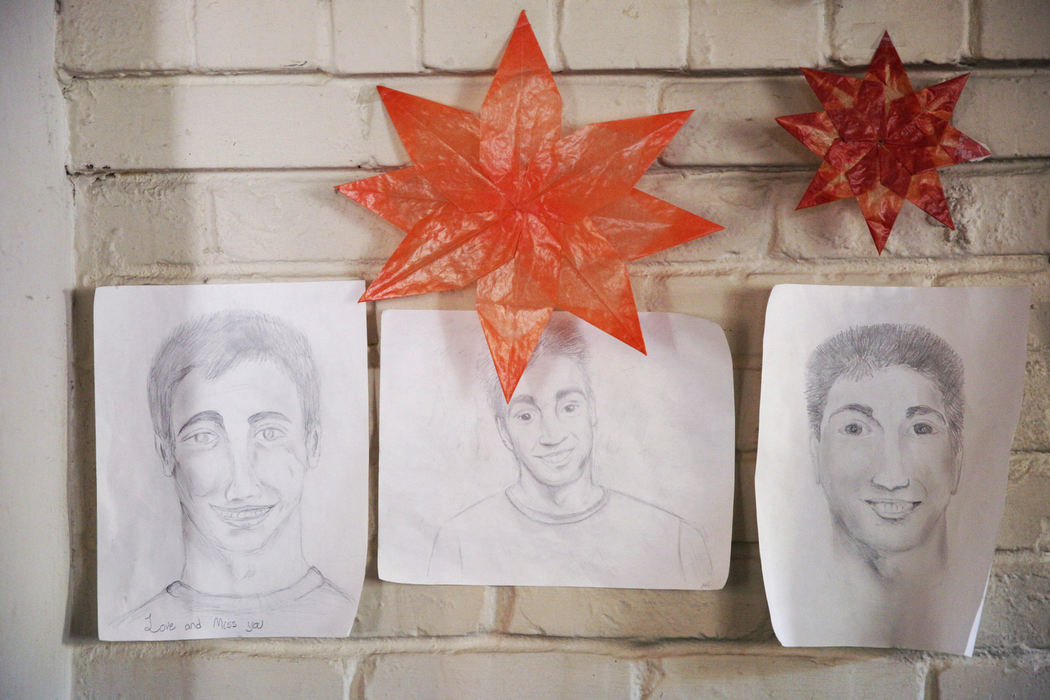 First Place, Feature Picture Story - Liz Moughon / Ohio University, "Finding Kyle"Drawings of Kyle hang at his home in Sacramento. His classmates drew the portraits a few days after his death, and his family has never taken them down.