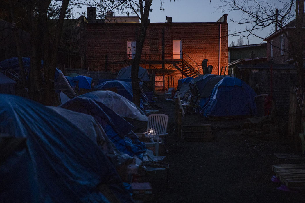 First Place, Larry Fullerton Photojournalism Scholarship - Nathaniel Bailey / Kent State UniversityThe sun sets on Tent City, showing light coming from security lamps installed by the low income apartment building next door. Multiple complaints about Tent City were filed by residents of that building, ranging from smells, to fights, to drug use and theft.
