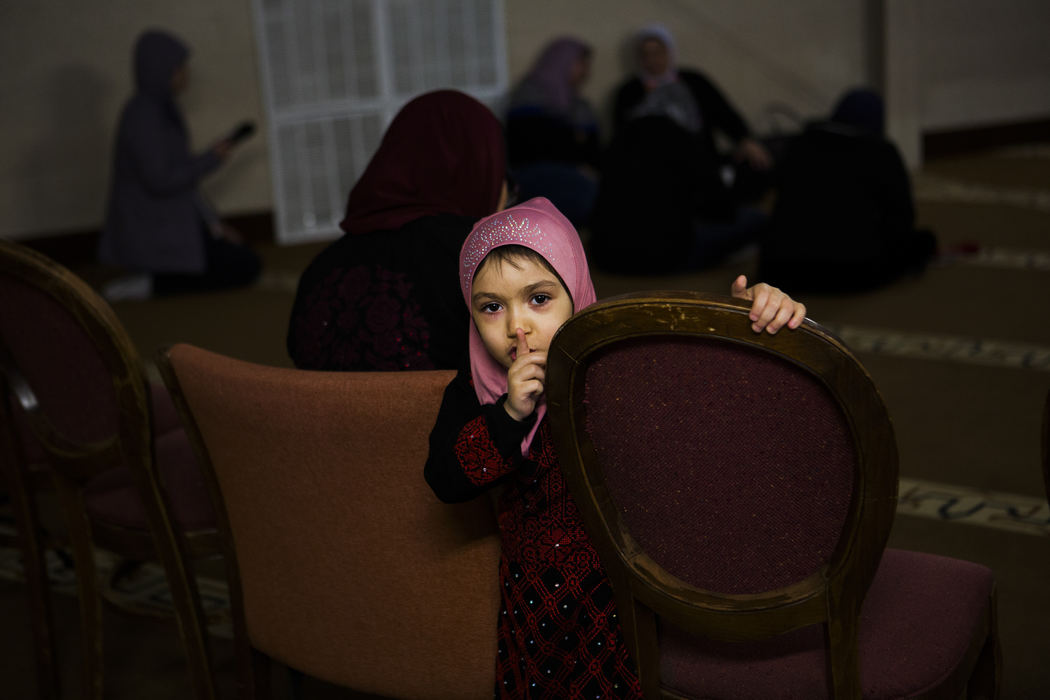 Second Place, Larry Fullerton Photojournalism Scholarship - Madeleine Hordinski / Ohio UniversitySarah Moustafa, 5, attends the Friday service at the Islamic Center of the Triad with her grandmother, Um Abdullah, on March 16, 2018, in Greensboro, North Carolina. 