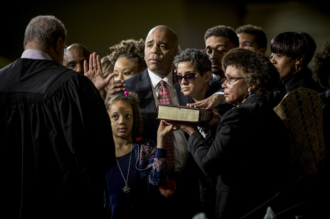 First Place, General News - Meg Vogel / The Cincinnati Enquirer, "Smitherman"Council Member Christopher Smitherman is sworn in as vice mayor while surrounded by his family at the inaugural session of the city council held at the Music Hall ballroom January 2, 2018. Smitherman's wife, Pamela, is battling breast cancer and was not expected to live to her husband's swearing in ceremony. Her family supports her to stand by her husband. 