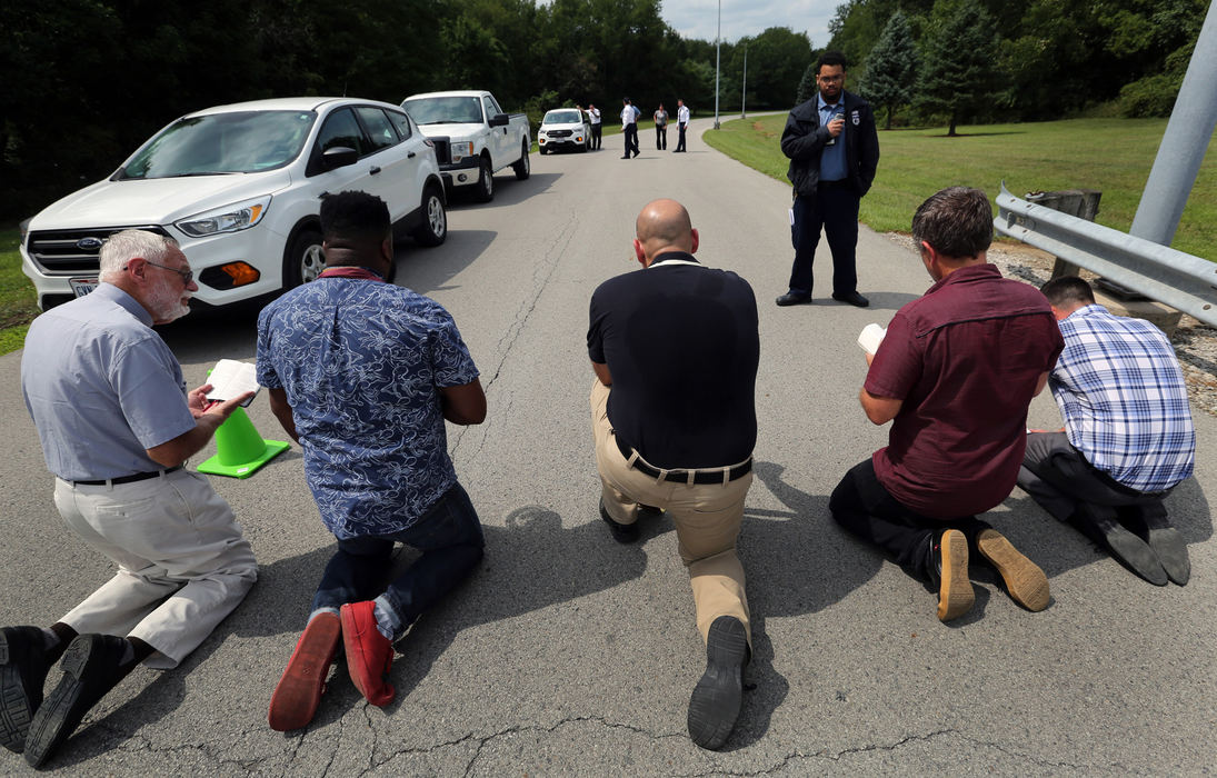 Third Place, News Picture Story - Gus Chan / The Plain Dealer, "Clergy Arrested"Members of various northeast Ohio clergy kneel as they block the entrance of the Northeast Ohio Correctional Center.  More than 50 members of Radial Church, Interreligious Task Force on Central America and Colombia, America’s Voice Ohio, and allies stood in support of about 300 immigrants detained at the Northeast Ohio Correctional Center, a for-profit prison owned by CoreCivic. 