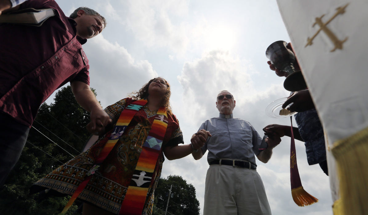 Third Place, News Picture Story - Gus Chan / The Plain Dealer, "Clergy Arrested"Chrissy Stonebraker-Martinez prays with pastors outside the Northeast Ohio Correctional Center. 