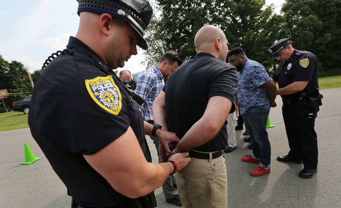 Third Place, News Picture Story - Gus Chan / The Plain Dealer, "Clergy Arrested"Pastor J.R. Rozco is arrested by Youngstown police after blocking the entrance of the Northeast Ohio Correctional Center.  
