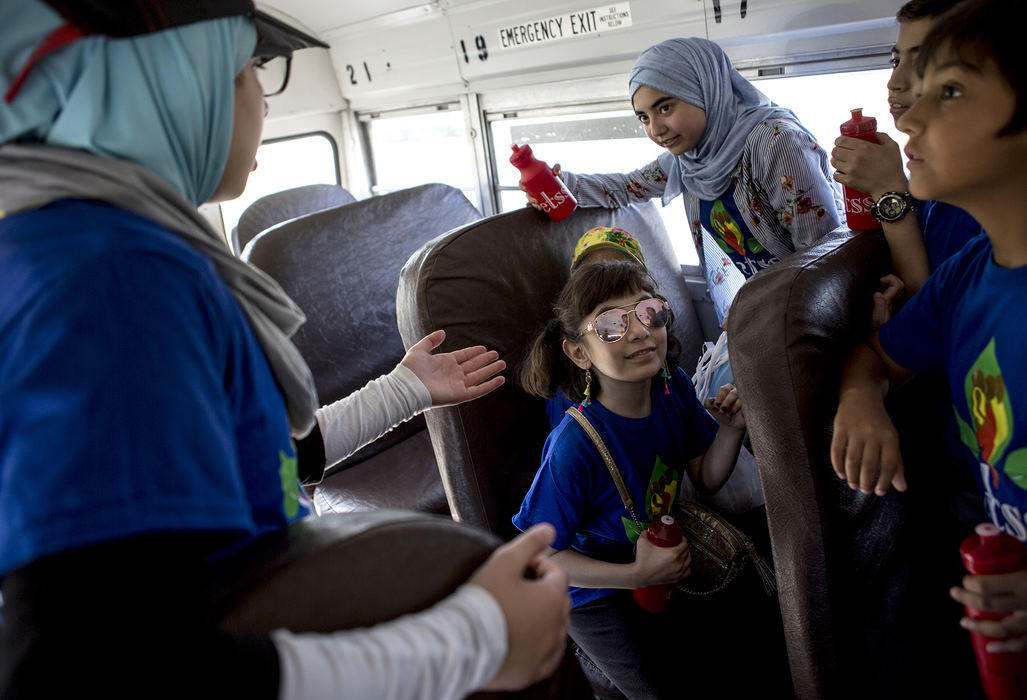 Second Place, Ohio Understanding Award - Jessica Phelps / Newark Advocate, "First Generation"Dima Al Haek (left) tries to get her sister, cousins and friends to sit down on a school bus before their summer youth program takes off for a field trip June 14, 2018. The group was heading to Blendon Woods Metro Parks and it was the first time most of them had the chance to wander through the woods.  Dima and her sister Maryam and parents Ahmed and Dunya all came to Ohio from Iraq by way of Syria in 2011. Their younger brother Mousa was born in Ohio. The family is finding a balance between Iraqi and American cultures, making sure their kids are strongly rooted in their faith and Iraqi traditions while letting them experience life in America. 