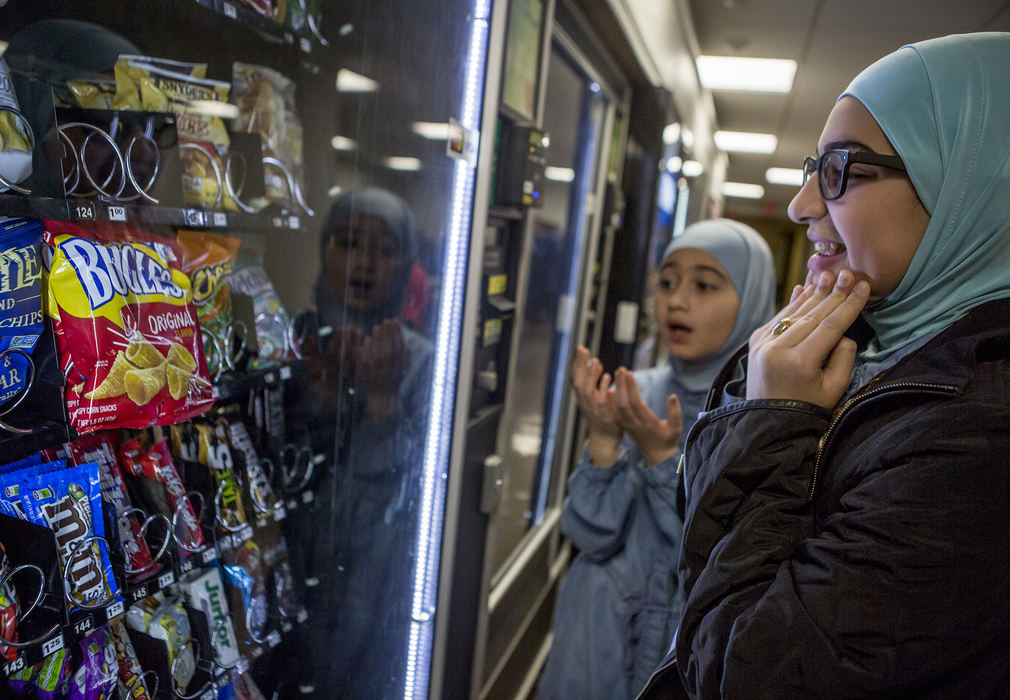 Second Place, Ohio Understanding Award - Jessica Phelps / Newark Advocate, "First Generation"Maryam (right) and her older sister, Dima (left) stare incredulously at the vending machine as their bag of Bugles gets stuck. The sisters were at the courthouse waiting for their mother, Dunya's naturalization ceremony on November 14, 2018. 