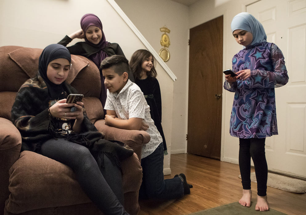 Second Place, Ohio Understanding Award - Jessica Phelps / Newark Advocate, "First Generation"Sisters Dima (far left) and Maryam (far right) play on their cell phones while their friends and cousins watch. The group were celebrating Dima's 13th birthday as well as her younger brother, Mousa's (not pictured) 4th birthday on November 25, 2017. 