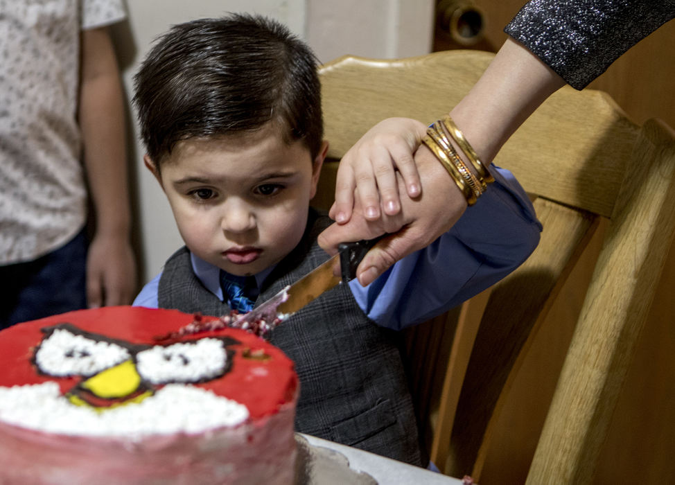 Second Place, Ohio Understanding Award - Jessica Phelps / Newark Advocate, "First Generation"Mousa Al Haek slowly cuts into his 'Angry Birds' birthday cake with help from his mom, Dunya on November 25, 2017. Moussa was born in the US, but his parents fled Iraq with his two older sisters after it became too dangerous for them to remain in Baghdad. His parents have been very careful to make sure their Iraqi traditions are not forgotten. They only speak Arabic in the home. Mousa, however has learned English by watching American cartoons, which is where he got his love of 'Angry Birds'.