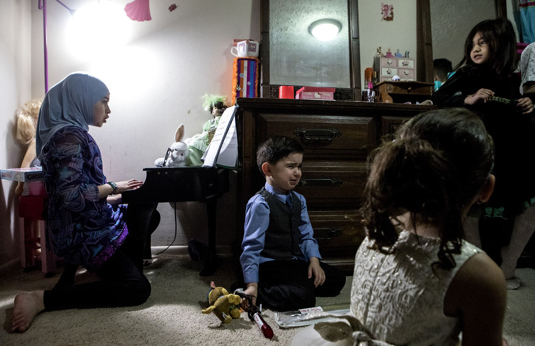 Second Place, Ohio Understanding Award - Jessica Phelps / Newark Advocate, "First Generation"Maryam Al Haek plays on her piano for her friends and cousins while her younger brother, Mousa because she would not let him play along with his recorder on November 25, 2017. 